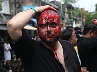 A Shi'ite Muslim man is mourning after flagellating himself during a Muharram procession marking Ashura, in Kolkata, India, on July 17, 2024...