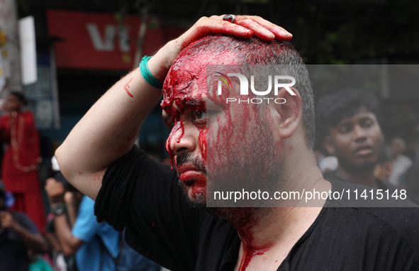 A Shi'ite Muslim man is mourning after flagellating himself during a Muharram procession marking Ashura, in Kolkata, India, on July 17, 2024...