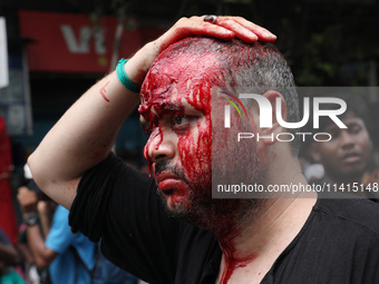 A Shi'ite Muslim man is mourning after flagellating himself during a Muharram procession marking Ashura, in Kolkata, India, on July 17, 2024...