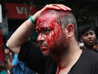 A Shi'ite Muslim man is mourning after flagellating himself during a Muharram procession marking Ashura, in Kolkata, India, on July 17, 2024...