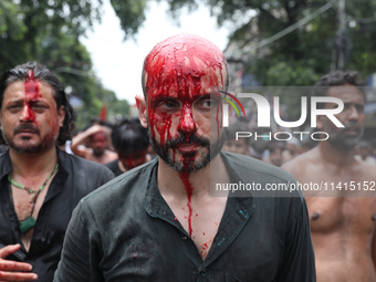 Shi'ite Muslims are walking after flagellating themselves during a Muharram procession marking Ashura in Kolkata, India, on July 17, 2024. (