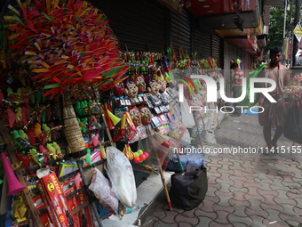 A vendor is arranging toys for selling during a Muharram procession marking Ashura, in Kolkata, India, on July 17, 2024. (