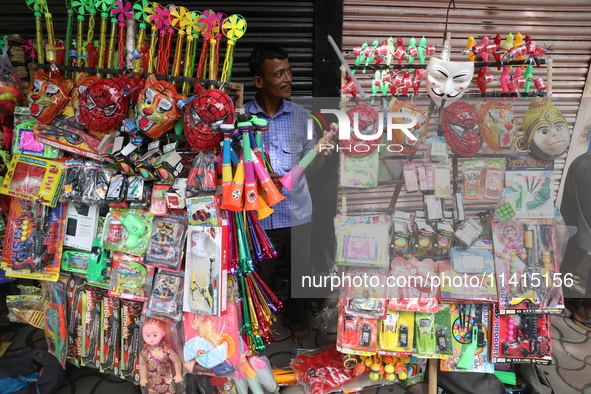 A vendor is arranging toys for selling during a Muharram procession marking Ashura, in Kolkata, India, on July 17, 2024. 