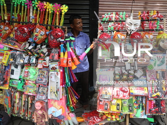 A vendor is arranging toys for selling during a Muharram procession marking Ashura, in Kolkata, India, on July 17, 2024. (