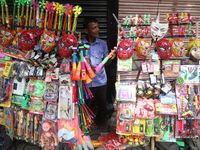 A vendor is arranging toys for selling during a Muharram procession marking Ashura, in Kolkata, India, on July 17, 2024. (