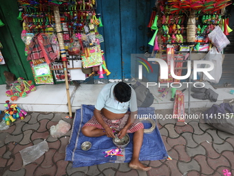 A vendor is making toys for selling during a Muharram procession marking Ashura in Kolkata, India, on July 17, 2024. (