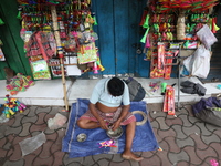 A vendor is making toys for selling during a Muharram procession marking Ashura in Kolkata, India, on July 17, 2024. (