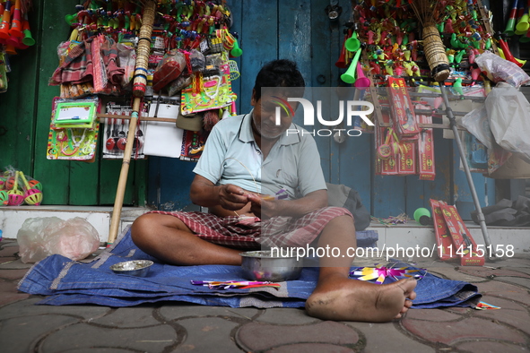 A vendor is making toys for selling during a Muharram procession marking Ashura in Kolkata, India, on July 17, 2024. 