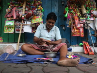 A vendor is making toys for selling during a Muharram procession marking Ashura in Kolkata, India, on July 17, 2024. (