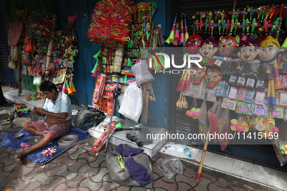 A vendor is making toys for selling during a Muharram procession marking Ashura in Kolkata, India, on July 17, 2024. 