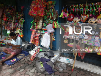 A vendor is making toys for selling during a Muharram procession marking Ashura in Kolkata, India, on July 17, 2024. (