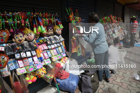 A vendor is arranging toys for selling during a Muharram procession marking Ashura, in Kolkata, India, on July 17, 2024. 