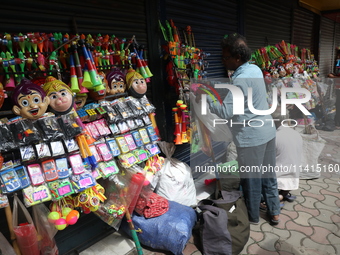 A vendor is arranging toys for selling during a Muharram procession marking Ashura, in Kolkata, India, on July 17, 2024. (