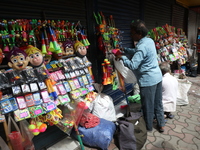 A vendor is arranging toys for selling during a Muharram procession marking Ashura, in Kolkata, India, on July 17, 2024. (