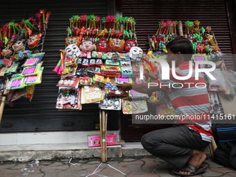 A vendor is arranging toys for selling during a Muharram procession marking Ashura, in Kolkata, India, on July 17, 2024. (