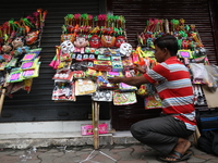 A vendor is arranging toys for selling during a Muharram procession marking Ashura, in Kolkata, India, on July 17, 2024. (