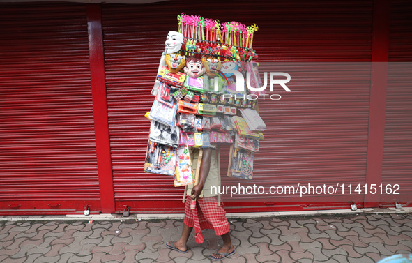 A vendor is walking after arranging toys for selling during a Muharram procession marking Ashura, in Kolkata, India, on July 17, 2024. 