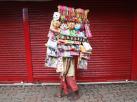 A vendor is walking after arranging toys for selling during a Muharram procession marking Ashura, in Kolkata, India, on July 17, 2024. (