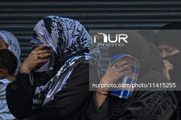 Shiite Muslim women are breaking down as they mourn during a procession to mark Ashura, in the old quarters of New Delhi, India, on July 17,...