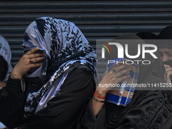 Shiite Muslim women are breaking down as they mourn during a procession to mark Ashura, in the old quarters of New Delhi, India, on July 17,...