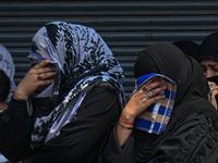 Shiite Muslim women are breaking down as they mourn during a procession to mark Ashura, in the old quarters of New Delhi, India, on July 17,...