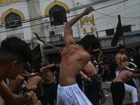 Shiite Muslims are flagellating themselves during a procession to mark Ashura, in the old quarters of New Delhi, India, on July 17, 2024. As...