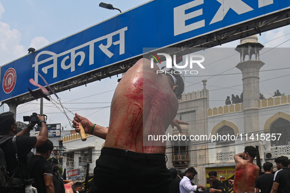 Shiite Muslims are flagellating themselves during a procession to mark Ashura, in the old quarters of New Delhi, India, on July 17, 2024. As...