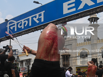 Shiite Muslims are flagellating themselves during a procession to mark Ashura, in the old quarters of New Delhi, India, on July 17, 2024. As...