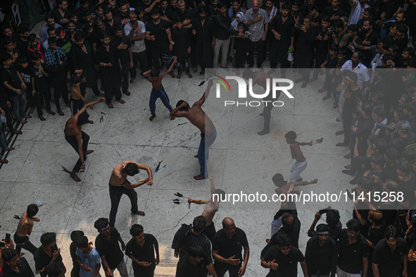 Shiite Muslims are flagellating themselves during a procession to mark Ashura, in the old quarters of New Delhi, India, on July 17, 2024. As...