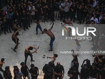 Shiite Muslims are flagellating themselves during a procession to mark Ashura, in the old quarters of New Delhi, India, on July 17, 2024. As...