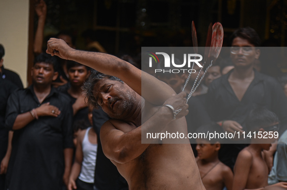 Shiite Muslims are flagellating themselves during a procession to mark Ashura, in the old quarters of New Delhi, India, on July 17, 2024. As...