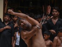 Shiite Muslims are flagellating themselves during a procession to mark Ashura, in the old quarters of New Delhi, India, on July 17, 2024. As...