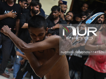 Shiite Muslims are flagellating themselves during a procession to mark Ashura, in the old quarters of New Delhi, India, on July 17, 2024. As...