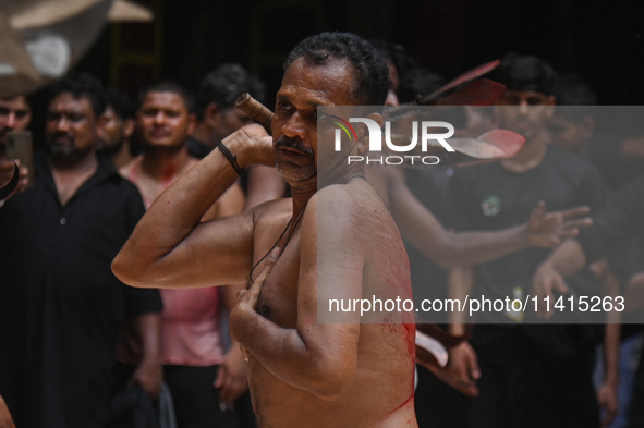 Shiite Muslims are flagellating themselves during a procession to mark Ashura, in the old quarters of New Delhi, India, on July 17, 2024. As...