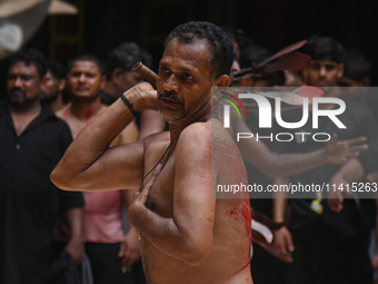 Shiite Muslims are flagellating themselves during a procession to mark Ashura, in the old quarters of New Delhi, India, on July 17, 2024. As...