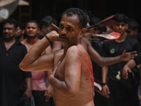 Shiite Muslims are flagellating themselves during a procession to mark Ashura, in the old quarters of New Delhi, India, on July 17, 2024. As...