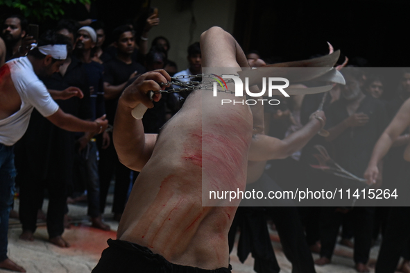 Shiite Muslims are flagellating themselves during a procession to mark Ashura, in the old quarters of New Delhi, India, on July 17, 2024. As...