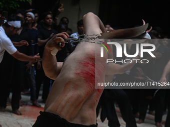 Shiite Muslims are flagellating themselves during a procession to mark Ashura, in the old quarters of New Delhi, India, on July 17, 2024. As...