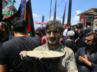 Kashmiri Shiite Muslim mourners are taking part in a religious procession on the tenth day of Ashura in the Islamic month of Muharram in Sri...