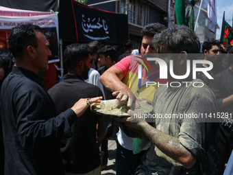 Kashmiri Shiite Muslim mourners are taking part in a religious procession on the tenth day of Ashura in the Islamic month of Muharram in Sri...