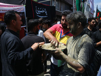 Kashmiri Shiite Muslim mourners are taking part in a religious procession on the tenth day of Ashura in the Islamic month of Muharram in Sri...