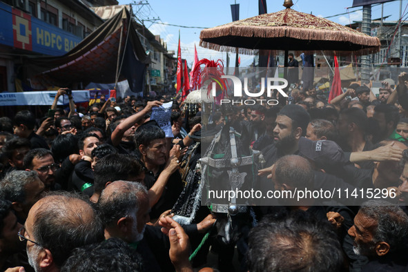 Kashmiri Shiite Muslims are reenacting the scene by touching the horse during a religious procession on the tenth day of Ashura in the Islam...