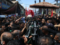 Kashmiri Shiite Muslims are reenacting the scene by touching the horse during a religious procession on the tenth day of Ashura in the Islam...