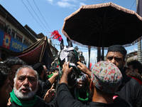 Kashmiri Shiite Muslims are reenacting the scene by touching the horse during a religious procession on the tenth day of Ashura in the Islam...