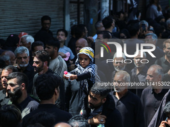 Kashmiri Shiite Muslim mourners are taking part in a religious procession on the tenth day of Ashura in the Islamic month of Muharram in Sri...