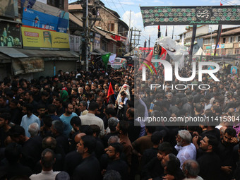 Kashmiri Shiite Muslim mourners are taking part in a religious procession on the tenth day of Ashura in the Islamic month of Muharram in Sri...