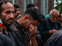 Kashmiri Shiite Muslims are chanting religious slogans as they take part in an Ashura procession during Muharram in Sopore, Jammu and Kashmi...