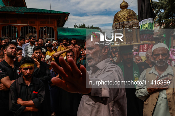 Kashmiri Shiite Muslims are chanting religious slogans as they take part in an Ashura procession during Muharram in Sopore, Jammu and Kashmi...