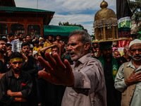 Kashmiri Shiite Muslims are chanting religious slogans as they take part in an Ashura procession during Muharram in Sopore, Jammu and Kashmi...