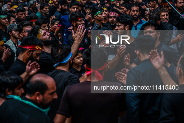 Kashmiri Shiite Muslims are chanting religious slogans as they take part in an Ashura procession during Muharram in Sopore, Jammu and Kashmi...